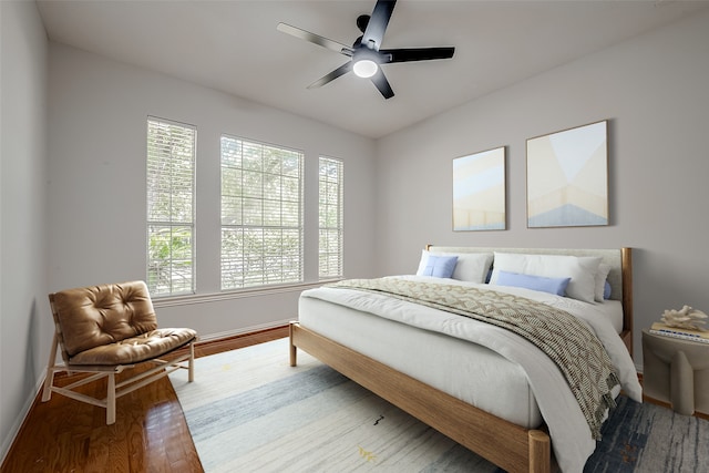 bedroom with ceiling fan and hardwood / wood-style floors