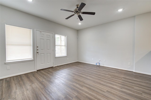 foyer entrance with ceiling fan and wood-type flooring