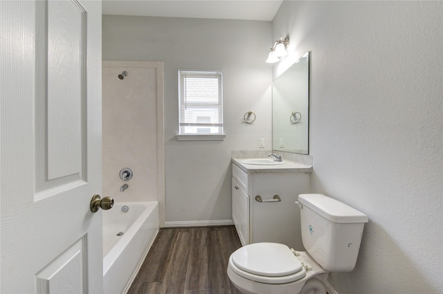 full bathroom with hardwood / wood-style floors, toilet, vanity, and shower / washtub combination