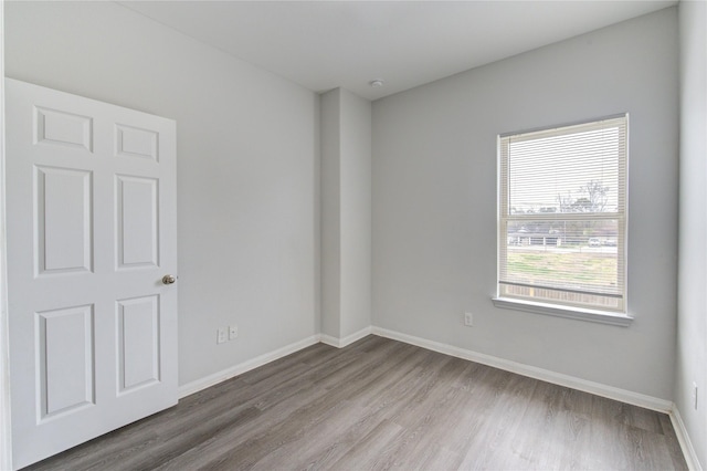 spare room with hardwood / wood-style floors