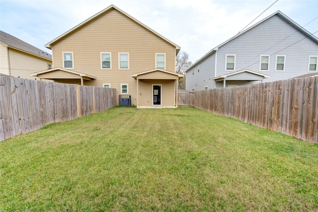 rear view of house with a yard