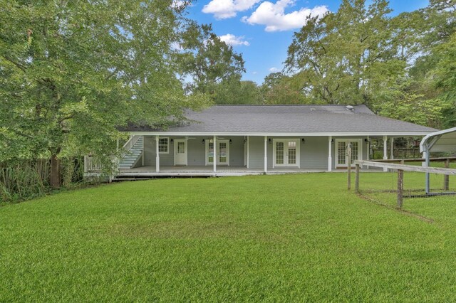 view of front of property with french doors, a carport, and a front yard