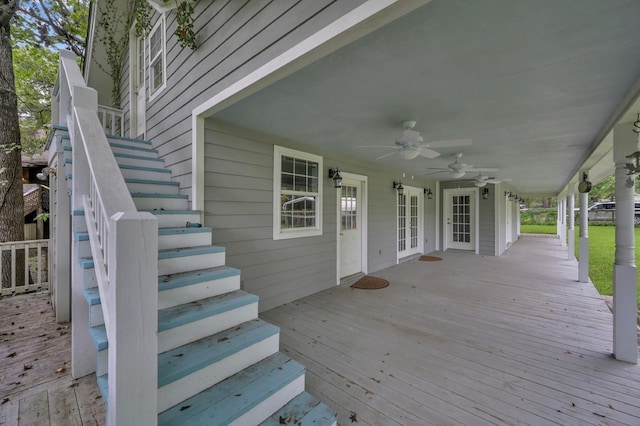 wooden terrace featuring ceiling fan, stairs, and french doors