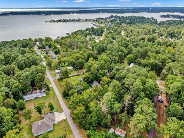 aerial view with a water view and a wooded view