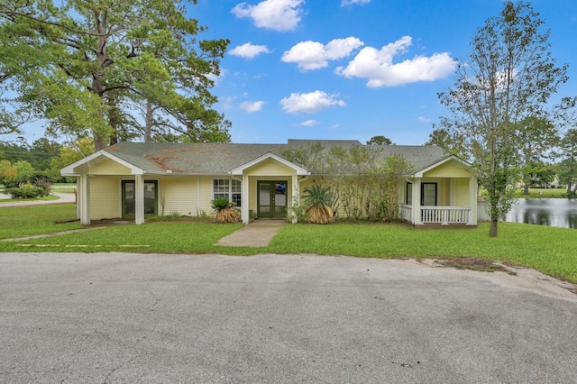 ranch-style house featuring a front yard and covered porch