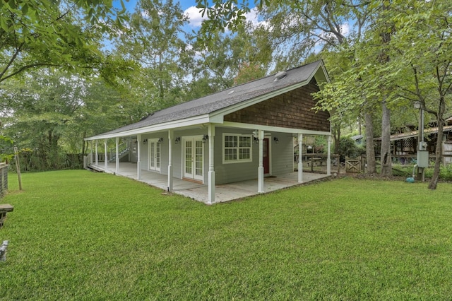 rear view of house featuring a patio area, fence, a lawn, and french doors