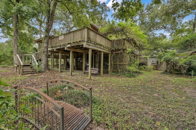 rear view of property with a wooden deck