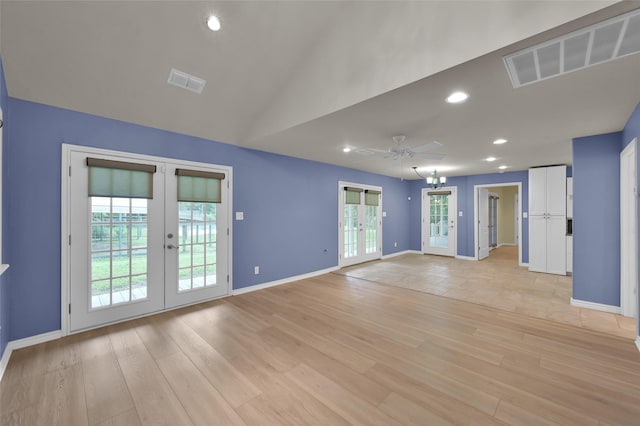 unfurnished living room with french doors, visible vents, and light wood-style floors