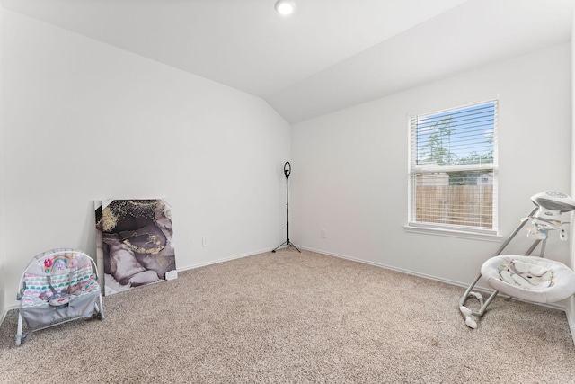 living area featuring carpet floors and vaulted ceiling