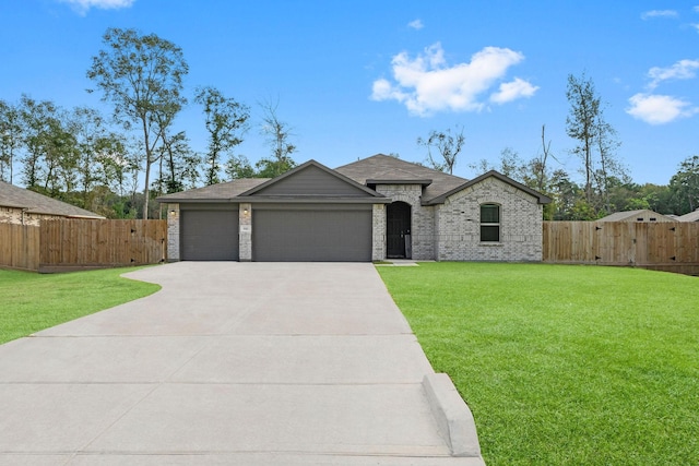 view of front of home with a garage and a front lawn