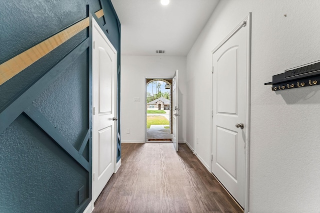 doorway to outside with dark wood-type flooring