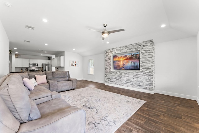 living room with ceiling fan, dark wood-type flooring, and lofted ceiling