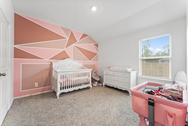 bedroom with a crib and carpet flooring