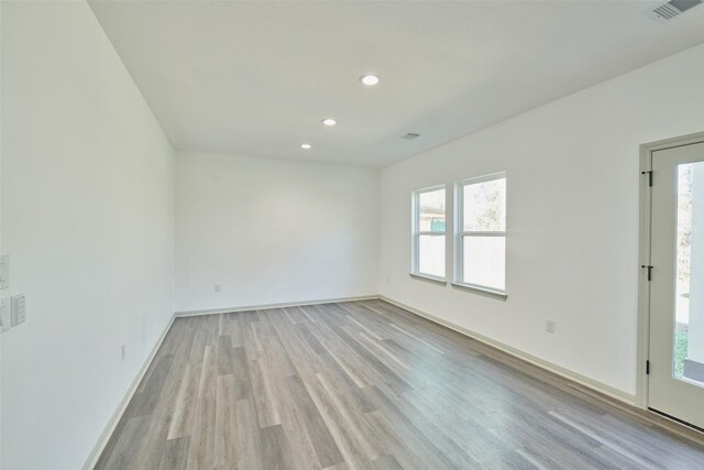 empty room with light hardwood / wood-style flooring