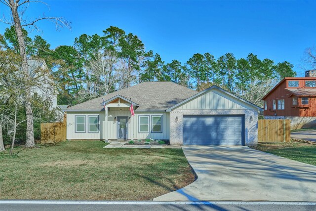 view of front facade featuring a garage and a front lawn