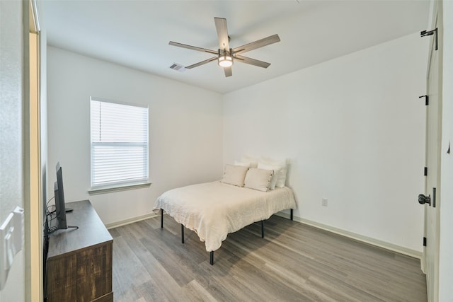 bedroom with light wood-type flooring and ceiling fan