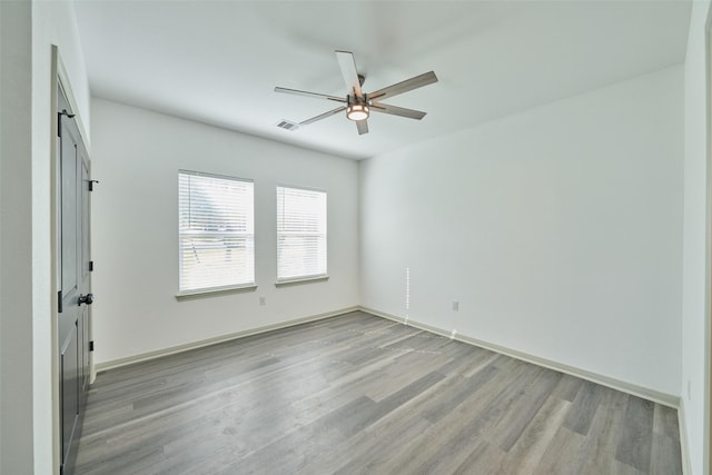 unfurnished room with ceiling fan and light wood-type flooring