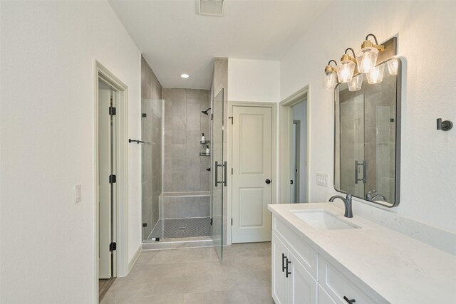 bathroom featuring walk in shower and vanity