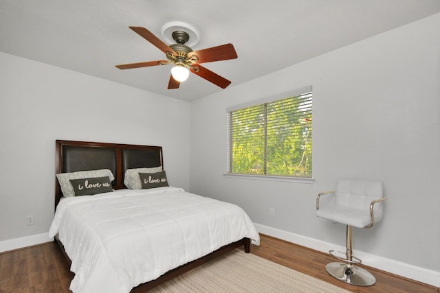 bedroom with dark wood-type flooring and ceiling fan