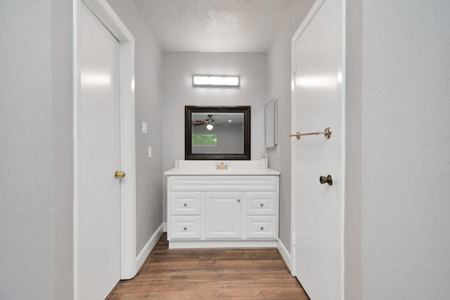 bathroom featuring vanity, hardwood / wood-style flooring, and a textured ceiling