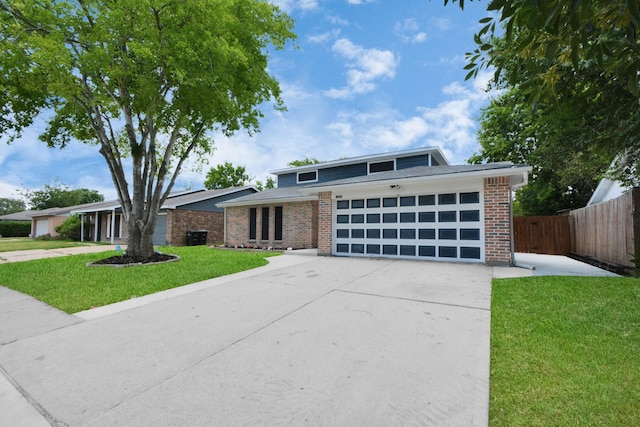 view of front of home featuring a garage, central AC, and a front yard