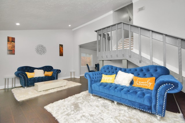 living room featuring lofted ceiling, dark wood-type flooring, and a textured ceiling