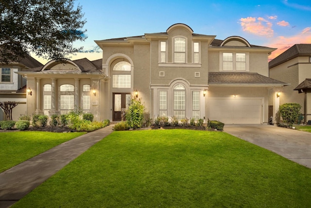 view of front of house with a lawn and a garage