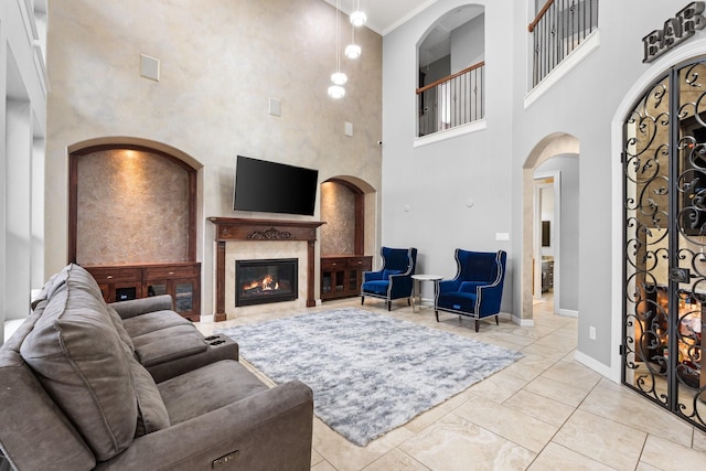 living room featuring a high ceiling and ornamental molding