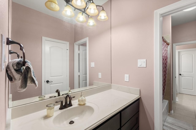 bathroom featuring vanity, a notable chandelier, and tile patterned flooring