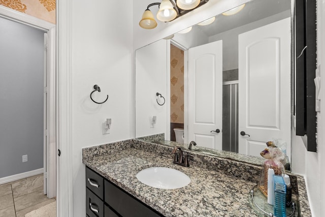 bathroom featuring vanity, a shower with shower door, and tile patterned floors