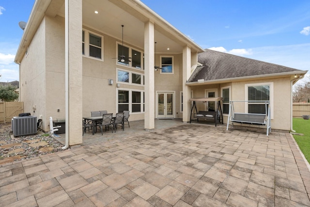 rear view of house with a patio area, cooling unit, and french doors