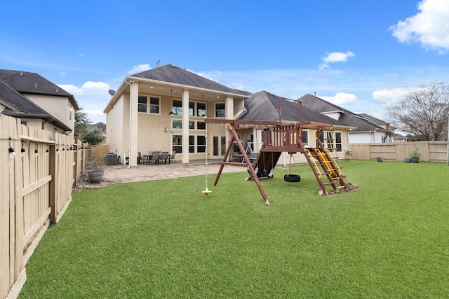 back of property featuring a patio, a playground, a lawn, and central AC