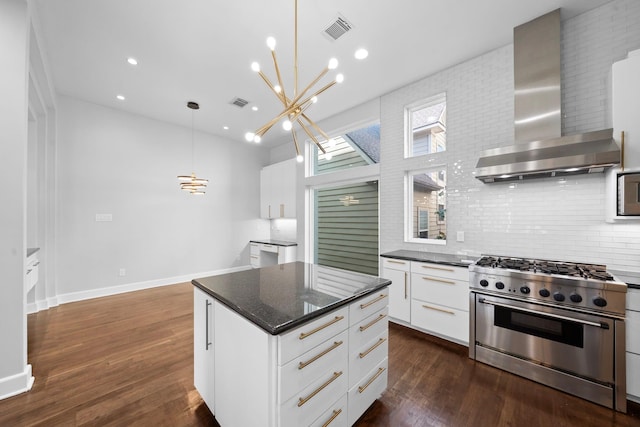 kitchen with hanging light fixtures, wall chimney exhaust hood, white cabinetry, stainless steel range, and dark hardwood / wood-style floors