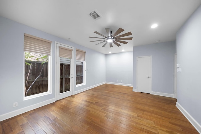 spare room with ceiling fan and wood-type flooring