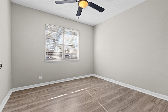 spare room featuring light wood-type flooring and ceiling fan