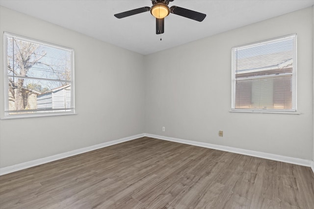 spare room featuring hardwood / wood-style floors and ceiling fan