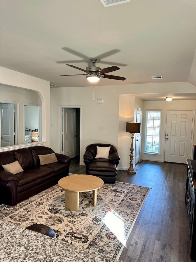 living room with ceiling fan and dark hardwood / wood-style flooring