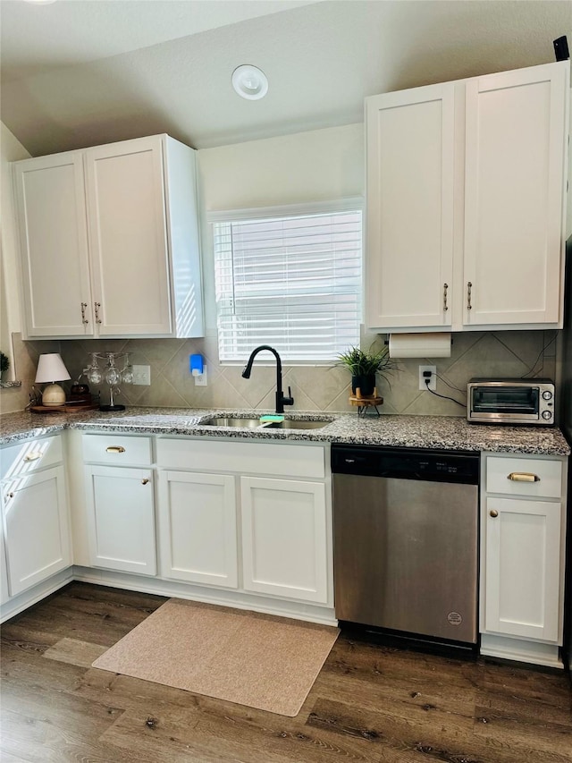 kitchen featuring sink, white cabinetry, stainless steel dishwasher, and dark hardwood / wood-style floors