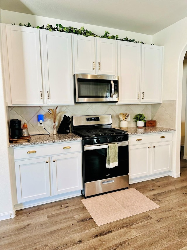 kitchen featuring white cabinetry and appliances with stainless steel finishes