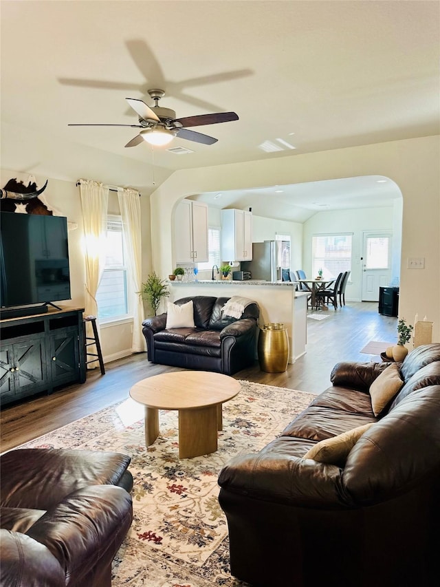 living room featuring ceiling fan, sink, and light wood-type flooring