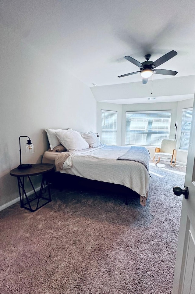 carpeted bedroom with ceiling fan and lofted ceiling