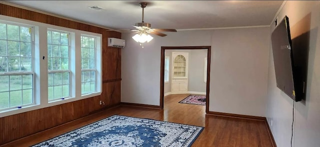 interior space featuring ceiling fan, dark hardwood / wood-style floors, crown molding, and a wall mounted AC