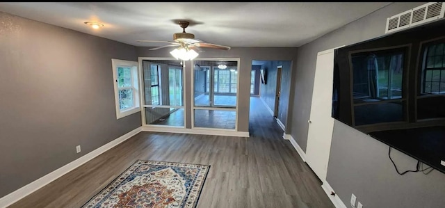 unfurnished dining area featuring ceiling fan and dark hardwood / wood-style floors