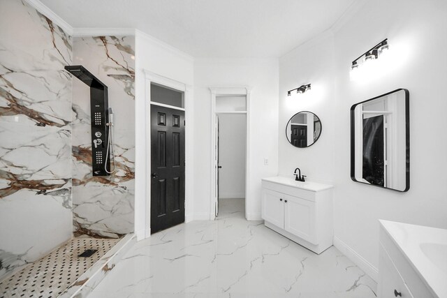 bathroom with vanity, ornamental molding, and tiled shower