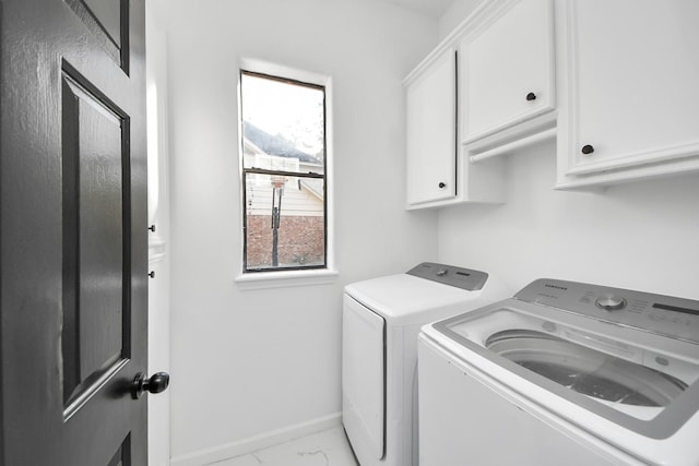 washroom with separate washer and dryer and cabinets