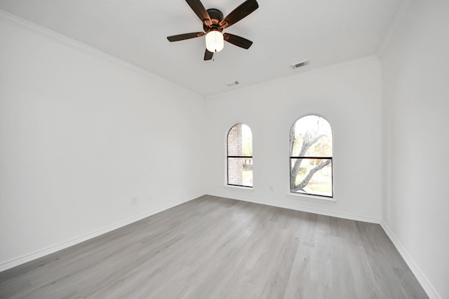 spare room featuring ceiling fan, ornamental molding, and light hardwood / wood-style flooring