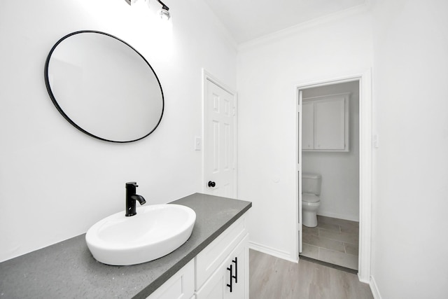 bathroom with vanity, hardwood / wood-style flooring, and toilet