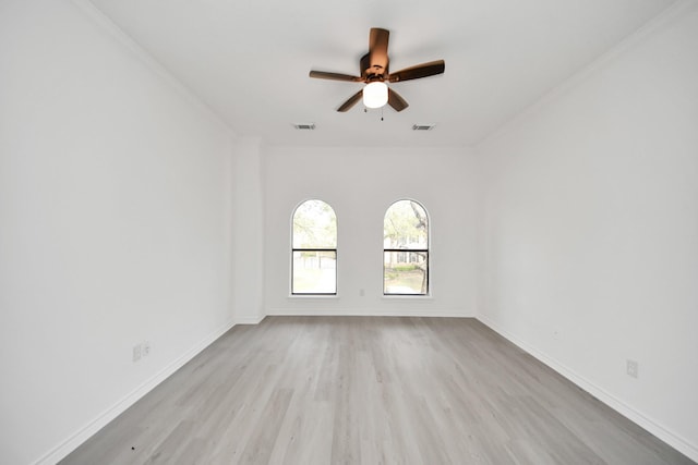 spare room featuring ceiling fan, ornamental molding, and light hardwood / wood-style floors