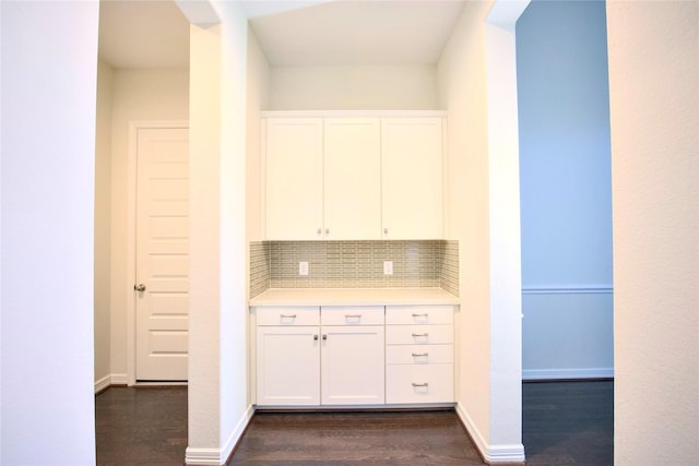 kitchen featuring decorative backsplash, white cabinetry, and dark hardwood / wood-style flooring