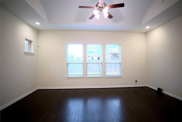 empty room with ceiling fan, dark wood-type flooring, and vaulted ceiling